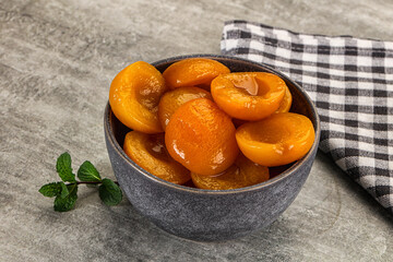 Sweet canned apricots with syrope