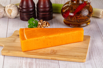 Yellow cheddae cheese over board