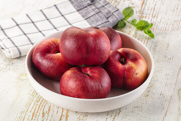 Ripe sweet juicy flat nectarines heap