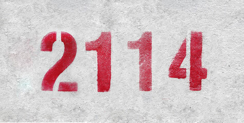 red spray-painted number 2114 sprayed onto a white wall.