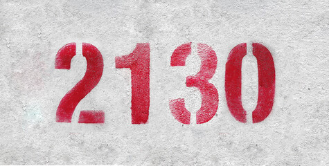 Red Number 2130 on the white wall. Spray paint.