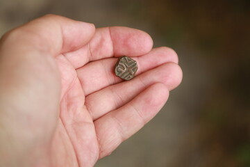 Antique copper Indian coin in hand