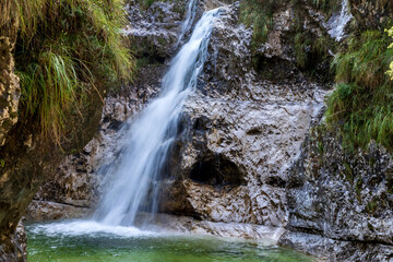 Cadini del Brenton, Dolomites, Italy waterfall and natural pools of transparent and crystalline water in limestone rocks, Dolomiti Bellunesi National Park