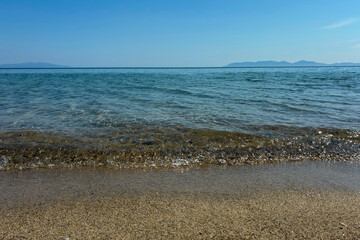 Idyllic Tropical Beach with Golden Sand, Crystal Clear Water, and Blue Sky. Summer Vacation, Relaxation, Nature Escape, Seaside Peaceful Horizon, Travel Background, for tourism and nature lovers.