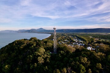 Aerial view of coastal town with communication tower.