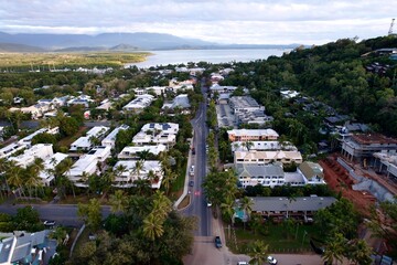 Aerial view of Port Douglas with lush greenery and mountains.