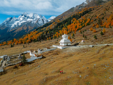 Aerial view of  Couple tourist relaxing  at  Mount Siguniang national park with the Beautiful  snow mountains in autumn, Chengdu ,Sichuan in China.