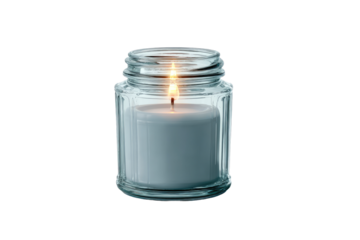 A clear glass jar candle with a lit flame