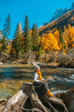 young  tourist explore and relaxing  at  Mount Siguniang national park with the Beautiful  snow mountains in autumn, Chengdu ,Sichuan in China.