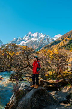 young  tourist explore and relaxing  at  Mount Siguniang national park with the Beautiful  snow mountains in autumn, Chengdu ,Sichuan in China.