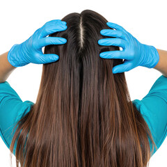Naklejka premium A person with long brown hair wearing blue gloves is placing their hands on their head, showing a clear middle hair part.