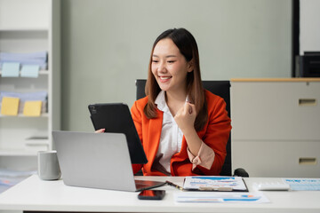 Overjoyed Asian woman celebrates a financial bonus. joyful smile, money success, and happiness...