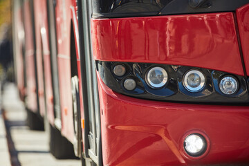 Red bus for public transportation on city streets.