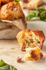 Savory egg muffin with bazil, ham and cheese on kitchen table background close up. Healthy and quick morning breakfast