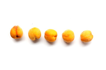 Fresh ripe apricots on a white background.
