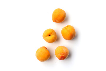 Fresh ripe apricots on a white background.