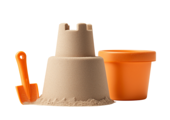 A simple sandcastle made with a beige color, next to an orange bucket and spade on a transparent background