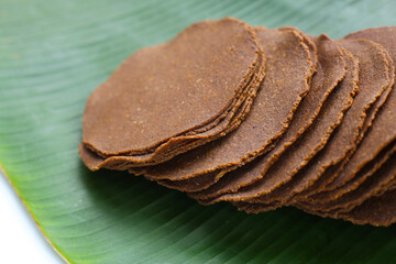 Fermented soybean discs, known as “Thua Nao,” a traditional Thai seasoning used to enhance...