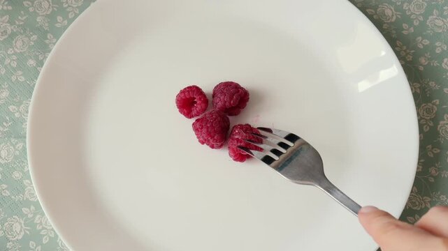 Extreme fruitarian diet concept. Raspberries on a plate. Diet