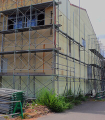A scaffolding surrounding the building that is being demolished.