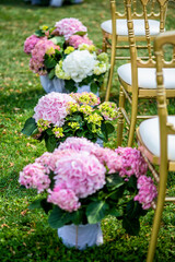 Wedding flower decoration with hydrangeas and golden chairs
