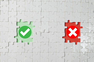 A concept of decision making. A puzzle with two missing pieces revealing a right (check mark) and wrong (cross mark) option. A symbol for business strategy, choices, and consequences.