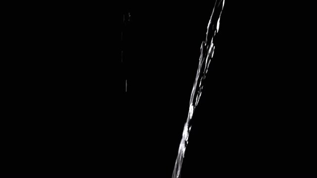 Thin Stream Of Water Pouring On Black Background. Close-up, slow motion. A clear stream of water flows down into empty space. Splashes. Abstract, texture, lighting. Clean water.