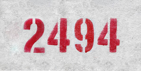 number 2494 . Red spray paint the white wall