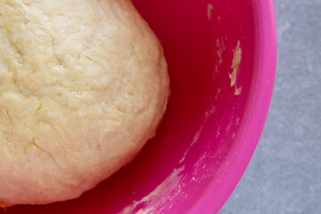smooth risen dough in a mixing bowl ready for baking