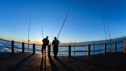 Fishermen Beach Pier Ocean Silhouetted Unrecognizable Persons Horizon Sunrise