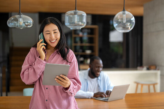 Couple of freelance IT specialists using digital technology devices while working remotely from home - Powered by Adobe