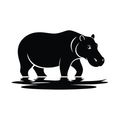 Silhouette of a hippopotamus gracefully walking through shallow water at sunset