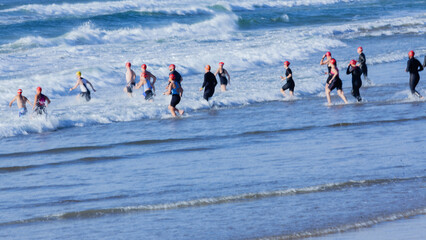 Triathlon Athletes Race Beach Ocean Entry Motion Blurs
