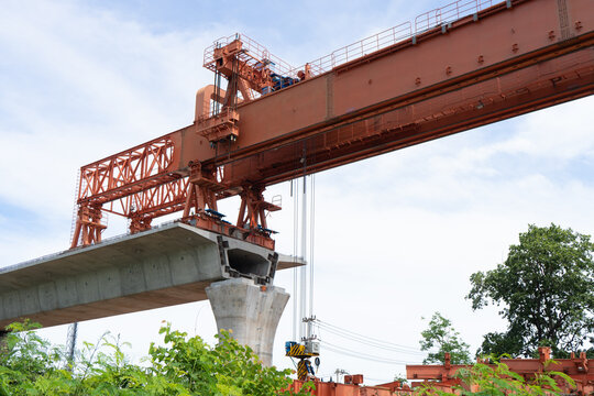 Workers construct bridge piers for a railway.