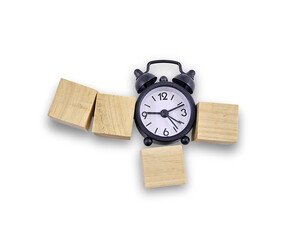 A black alarm clock surrounded by wooden blocks, suggesting time management or deadlines.