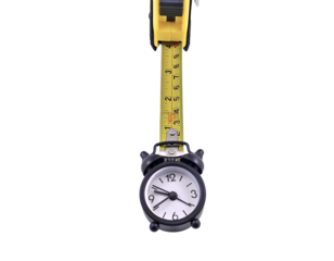 A yellow tape measure holds a small black alarm clock against a white background.