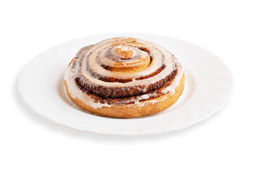 Portion of delicious sweet homemade cinnamon roll bun or swirl glazed with sugar icing served on plate isolated on white background freshly baked as breakfast pastry dessert or seasonal comfort food