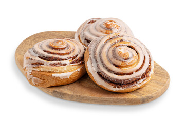 Three delicious sweet freshly baked cinnamon rolls bun or swirl glazed with sugar icing served on...