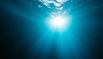 Fototapeta premium Underwater sunlight shining through the water surface