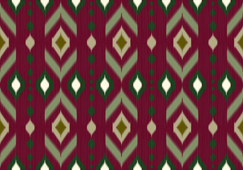 This seamless ikat pattern features bold maroon and green chevron diamonds with earthy tones and blurred edges, giving a traditional, handcrafted textile feel with modern symmetry.