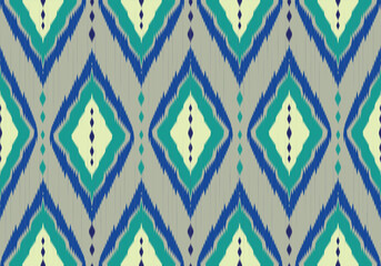 A vibrant seamless ikat pattern with diamond motifs in aqua, navy, and ivory tones on a light gray background, creating a rhythmic tribal and ethnic textile design.
