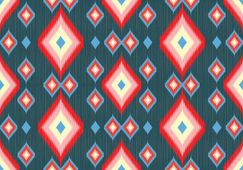 A dynamic seamless ikat fabric with layered diamond motifs in red, cream, blue, and pink over a dark teal background, conveying vibrant folk tradition and energy.
