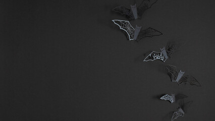 Black Halloween background with bats creating a festive and creepy Halloween atmosphere.