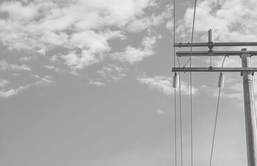 Power pole with cables, insulators against clear blue sky. Electric power distribution, high-voltage transmission system. Energy supply tech background.