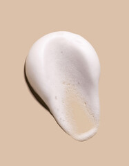 texture foam mousse foam cosmetic smear sample on beige background