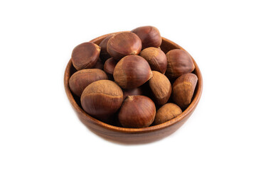 wooden bowl with raw edible Сhestnuts Isolated on white, side view, close up, minimalism