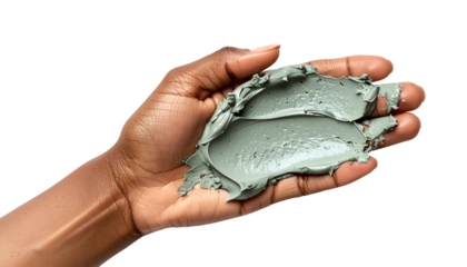 Dark skin hand holding green facial clay mask on palm on isolated white background