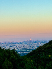 Sunset Over Mountain Ridge with Distant City Skyline