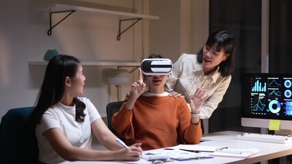 Office professional wearing virtual reality goggles, exploring immersive digital environment while colleagues observing and taking collaborative notes during innovative technology demonstration