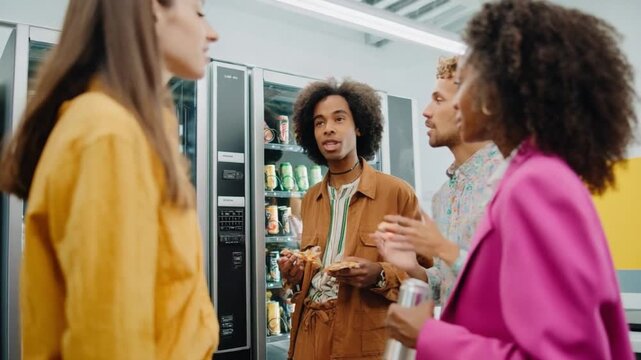 Vending Machine Discussion: A group of diverse individuals engages in a vibrant discussion near a sleek vending machine, capturing a candid moment of camaraderie and interaction.